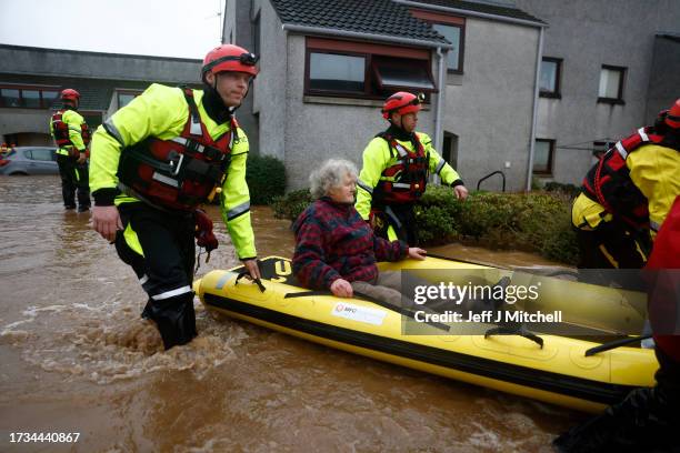 Members of the coastguard rescue a woman from flood waters surrounding her home on October 20, 2023 in Brechin, Scotland. Areas close to the river...