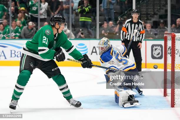 Jason Robertson of the Dallas Stars scores past Jordan Binnington of the St. Louis Blues during a shootout in the season opening game at American...