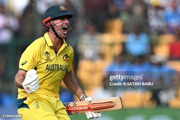 Australia's Mitchell Marsh celebrates after scoring a century during the 2023 ICC Men's Cricket World Cup one-day international match between...