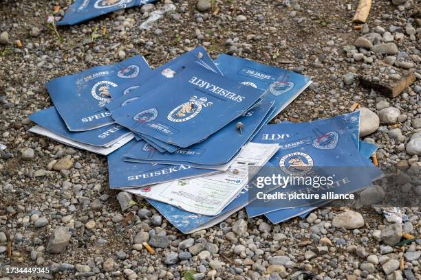 October 2023, Bavaria, Munich: Discarded menus lie in front of a beer tent on the Oktoberfest grounds. The 188th Oktoberfest took place this year...