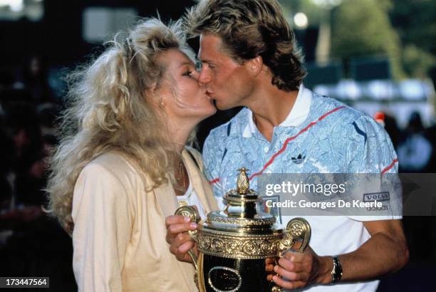 Swedish player Stefan Edberg and his girlfriend Annette Olsen pose with his trophy after winning the Men's Singles at the Wimbledon Championships on...