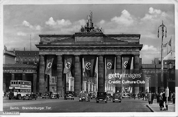 The Brandenburg Gate / Brandenburger Tor. Nazi party flags cover the city gate. Postcard stamped on rear 7 July 1941.