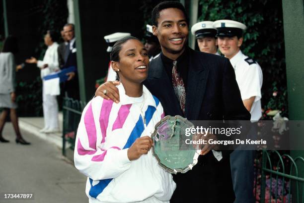 Tennis player Zina Garrison and her husband Willard Jackson pose with her trophy after getting 2nd place at Women's Singles at the Wimbledon...