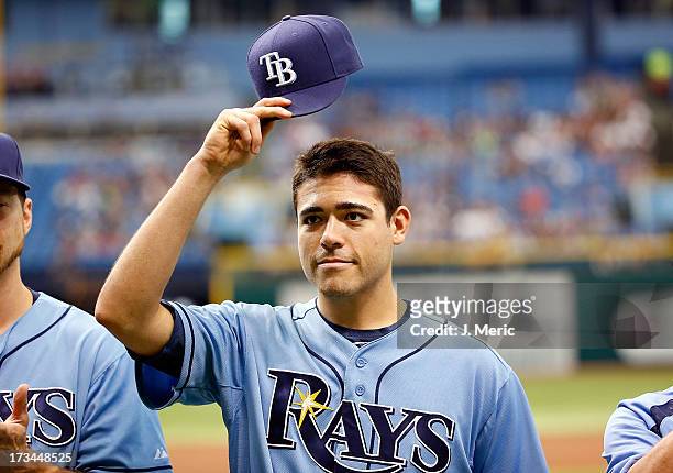 Pitcher Matt Moore of the Tampa Bay Rays tips his hat as he receives his all star jersey just before the start of the game against the Houston Astros...