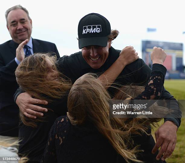 Phil Mickelson of the United States embraces his children Evan, Amanda and Sophia after his victory on the 1st hole of a sudden-death playoff during...