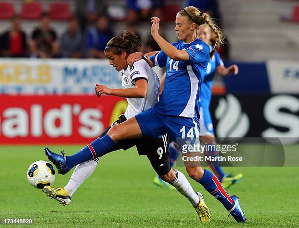 Dagny Brynjatsdottir of Iceland and Lena Lotzen of Germany battle for the ball during the UEFA Women's Euro 2013 group B match between Iceland and...