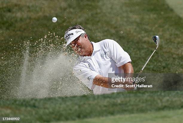 Kenny Perry plays a bunker shot on the sixth hole during the final round of the 2013 U.S. Senior Open Championship at Omaha Country Club on July 14,...