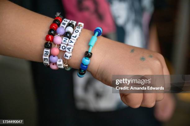 Young Taylor Swift fan, friendship bracelet detail, attends the opening night theatrical release of "Taylor Swift : The Eras Tour" at AMC DINE-IN...