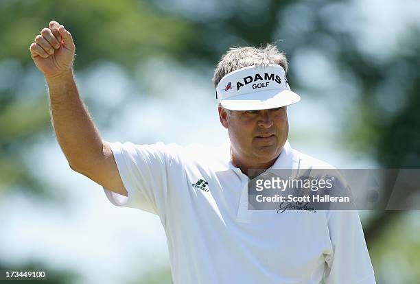 Kenny Perry celebrates a birdie putt on the second green during the final round of the 2013 U.S. Senior Open Championship at Omaha Country Club on...