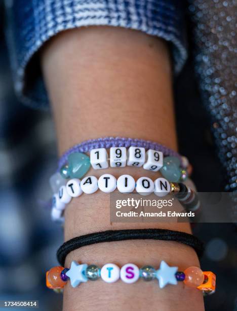 Taylor Swift fan, friendship bracelet detail, attends the opening night theatrical release of "Taylor Swift : The Eras Tour" at AMC Marina...