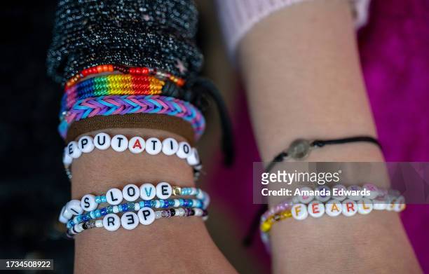 Taylor Swift fans, friendship bracelet detail, attend the opening night theatrical release of "Taylor Swift : The Eras Tour" at AMC Marina...