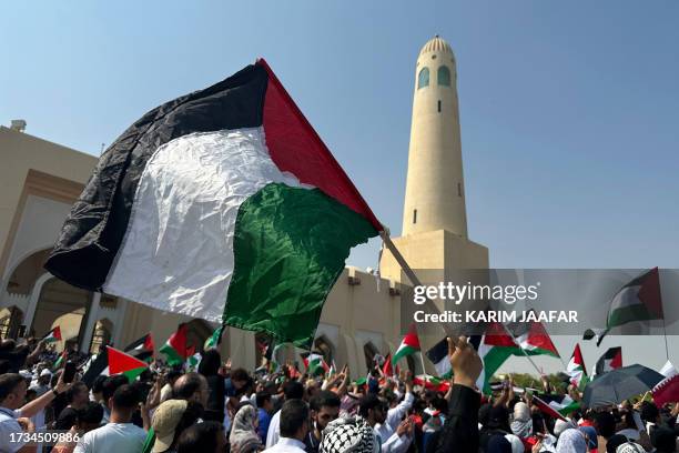 People wave the Palestinian flag during protests outside the Imam Muhammad Abdel-Wahhab Mosque in support of the Palestinian people following Friday...