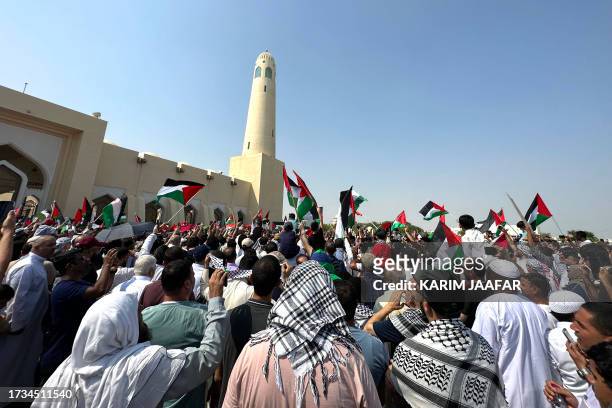 People wave the Palestinian flag during protests outside the Imam Muhammad Abdel-Wahhab Mosque in support of the Palestinian people following Friday...