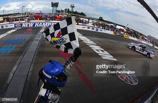 Brian Vickers, driver of the Aaron's Dream Machine Toyota, celebrates with the checkered flag after winning the NASCAR Sprint Cup Series Camping...