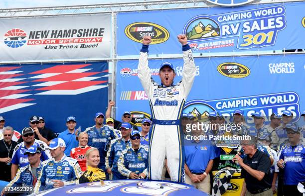 Brian Vickers, driver of the Aaron's Dream Machine Toyota, celebrates in Victory Lane after winning the NASCAR Sprint Cup Series Camping World RV...