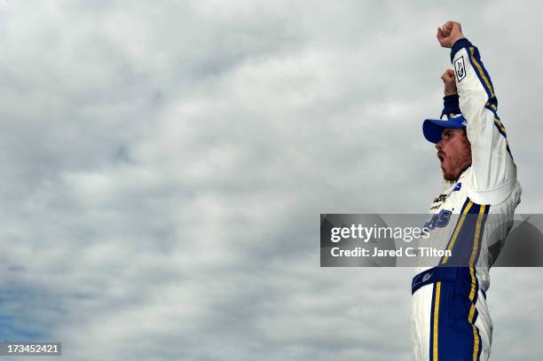 Brian Vickers, driver of the Aaron's Dream Machine Toyota, celebrates in Victory Lane after winning the NASCAR Sprint Cup Series Camping World RV...