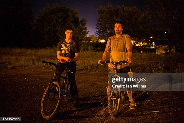 Two local residents out for a bicycle ride along the railway tracks, on the outskirts July 13, 2013 in Lac-Megantic, Quebec, Canada. A train derailed...