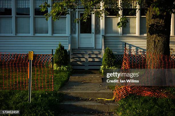 Ripped police tape is seen in the entrance to a home on July 13, 2013 in Lac-Megantic, Quebec, Canada. A train derailed and exploded into a massive...