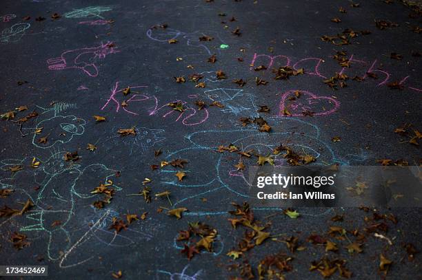 Children's chalk drawings, less than a block from the "red zone" crash site, on July 14, 2013 in Lac-Megantic, Quebec, Canada. A train derailed and...