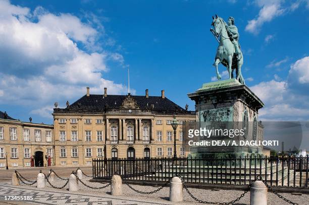 Equestrian statue of Frederick V, Amalienborg Palace in the background , Danish royal residence, Copenhagen, Denmark.