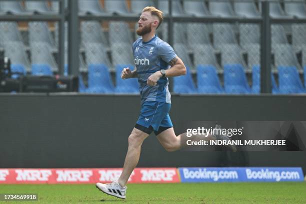 England's Ben Stokes jogs during a training session at the Wankhede stadium in Mumbai on October 20, 2023 ahead of their 2023 ICC Men's Cricket World...