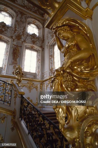 Golden statue, grand staircase of the Grand Palace , design by the architect Bartolomeo Francesco Rastrelli, Peterhof , near St Petersburg, Russia.