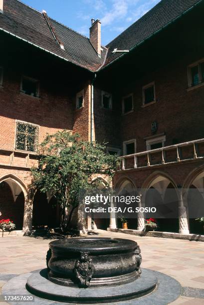 View of the inner courtyard with the well of the Collegium Maius building , Jagiellonian University, historic centre of Krakow , Lesser Poland...