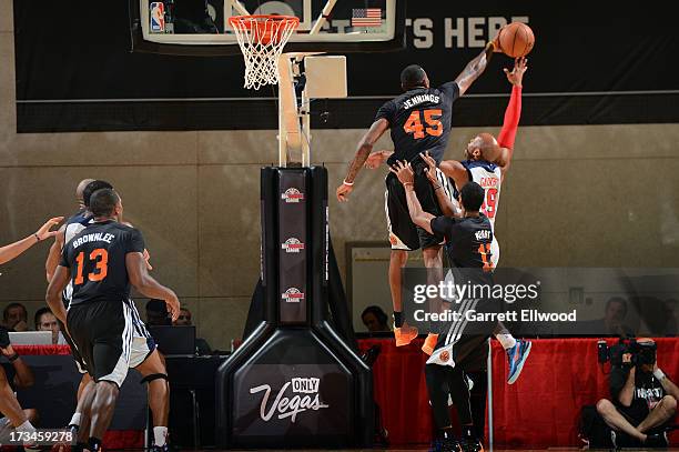 Terrence Jennings of the New York Knicks blocks a shot against Sundiata Gaines of the Washington Wizards during NBA Summer League on July 14, 2013 at...