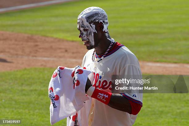 John Mayberry Jr. #15 of the Philadelphia Phillies gets shaving creamed after singling in the winning run in the 10th inning against the Chicago...