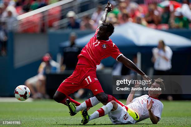 Cecilio Waterman of Panama gets tangled up with Nikolas Ledgerwood of Canada while battling for the ball during the second half of a CONCACAF Gold...