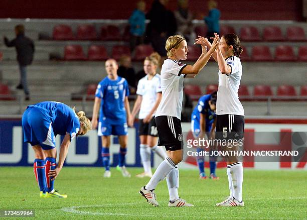 Germany's players celebrates after winning the UEFA Women's European Championship Euro 2013 group B football match Iceland vs Germany on July 14,...