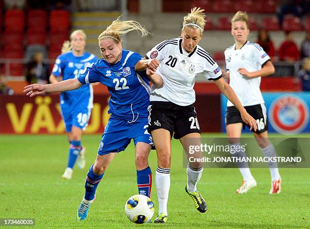 Iceland's forward Rakel Honnudottir and Germany's midfielder Lena Goessling vie for the ball during the UEFA Women's European Championship Euro 2013...