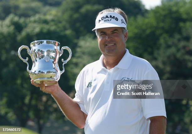 Kenny Perry poses with the trophy after his five-stroke victory at the 2013 U.S. Senior Open Championship at Omaha Country Club on July 14, 2013 in...