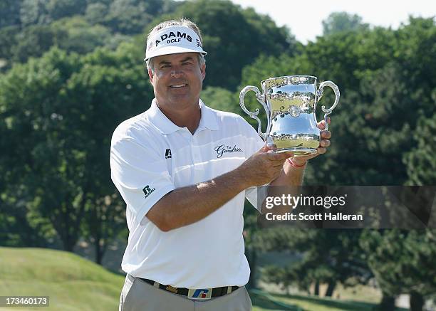 Kenny Perry poses with the trophy after his five-stroke victory at the 2013 U.S. Senior Open Championship at Omaha Country Club on July 14, 2013 in...