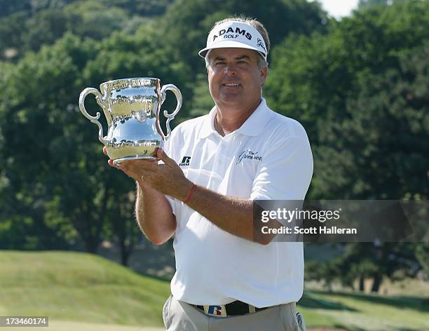 Kenny Perry poses with the trophy after his five-stroke victory at the 2013 U.S. Senior Open Championship at Omaha Country Club on July 14, 2013 in...