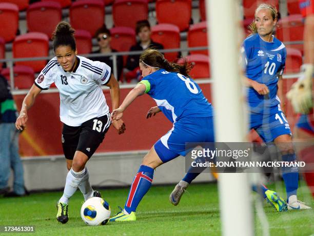 German forward Celia Okoyino da Mbabi controls the ball during the UEFA Women's European Championship Euro 2013 group B football match Iceland vs...