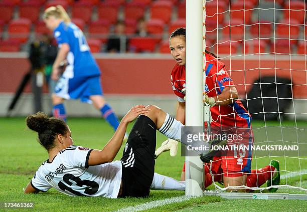 Iceland's goalkeeper Gudbjorg Gunnarsdottir reacts to an attempt by Germany's forward Celia Okoyino da Mbabi during the UEFA Women's European...