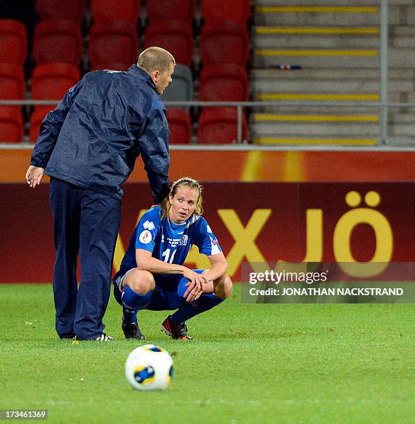 Iceland's head coach Sigurdur Eyjolfsson and forward Harpa Thorsteinsdottir react after loosing the UEFA Women's European Championship Euro 2013...