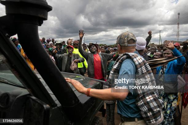 Victims of British Army Training Unit in Kenya training activities and their families block traffic during a demonstration following a meeting with...