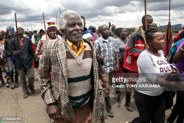 Victims of British Army Training Unit in Kenya training activities and their families hold a demonstration following a meeting with their legal...