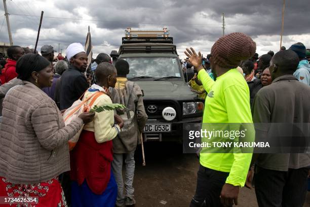 Victims of British Army Training Unit in Kenya training activities and their families block traffic during a demonstration following a meeting with...