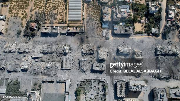 An aerial view shows destoyed buildings in al-Zahra city south of Gaza City on October 20, 2023 following Israeli bombardment overnight amid ongoing...
