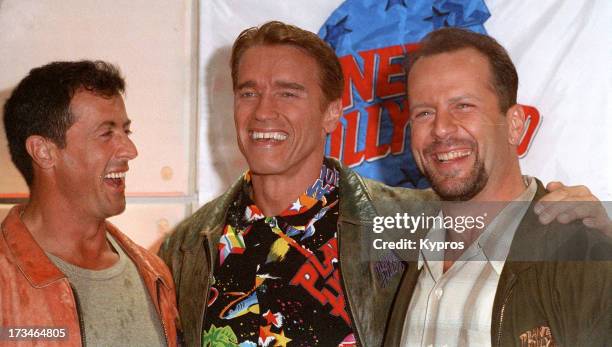 From left to right, actors Sylvester Stallone, Arnold Schwarzenegger and Bruce Willis at Planet Hollywood, circa 1990.