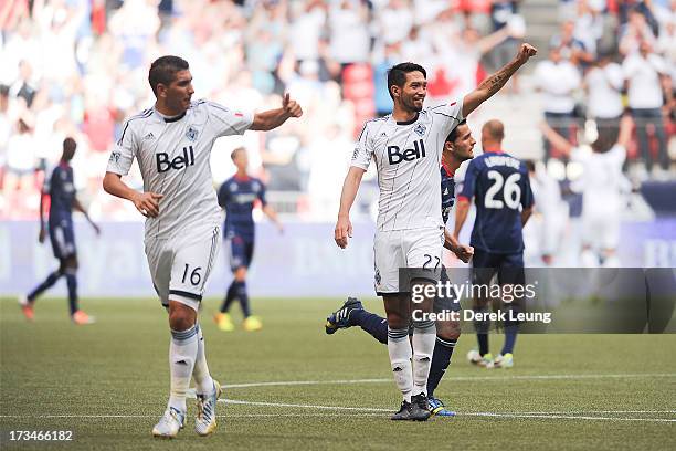 Jun Marques Davidson and Johnny Leveron of the Vancouver Whitecaps celebrate the Whitecaps' first goal scored by their teammate Camilo Sanvezzo...