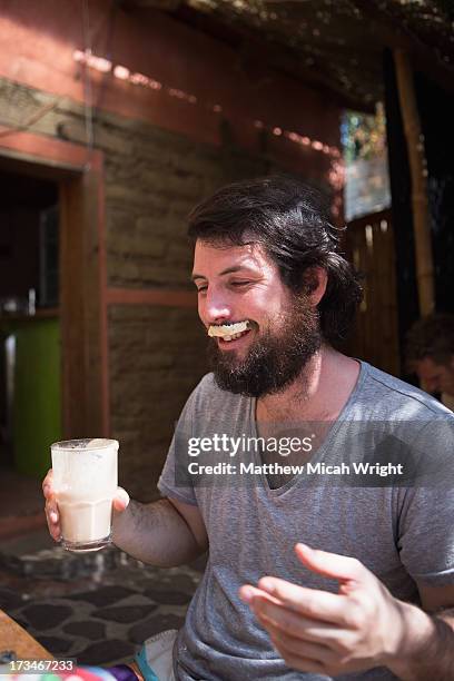 a man sports a milk moustache from coffee - milk moustache stock-fotos und bilder