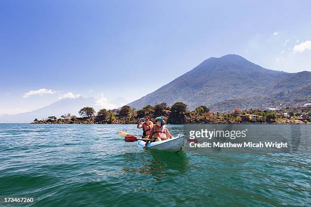 a journey across lake atitlan by kayak - central america stock pictures, royalty-free photos & images