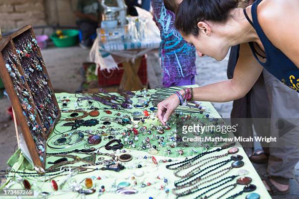 a woman browses through local trinkets - san pablo la laguna stock pictures, royalty-free photos & images