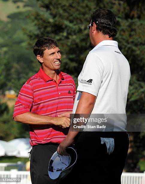 Steven Alker of New Zealand shakes hands with Ashley Hall of Australia after Alker won in a one hole playoff during the final round of the Utah...