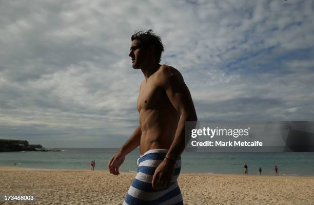 Josh Kennedy walks along the beach during a Sydney Swans AFL recovery session at Coogee Beach on July 15, 2013 in Sydney, Australia.