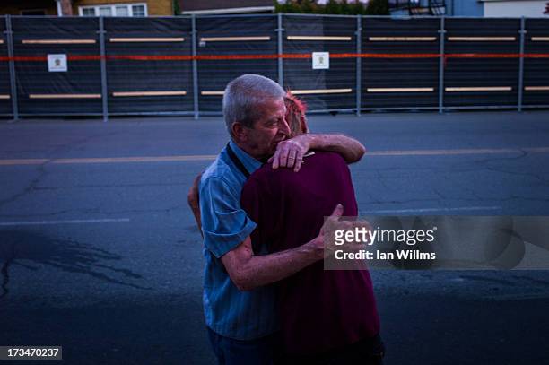 Marcel Larrivee comforts Patricia Landry after the pair first witnessed the aftermath of the destruction on July 14, 2013 in Lac-Megantic, Quebec,...